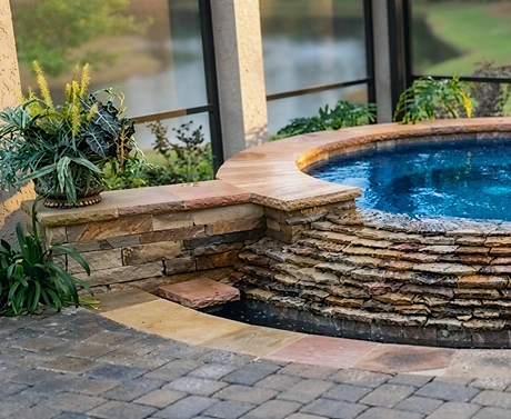 21 Holly Grove — a round stacked-stone spa and its spillway